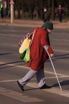 Old woman with problems crossing the street