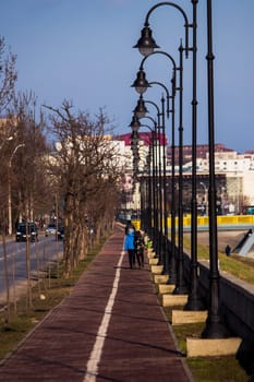 Children walking on a sidwalk with poles  in Iasi, Romania