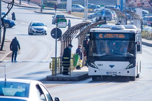 Iasi - Romania - 13th March 2021: Bus station with people waiting and traffic