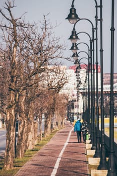 Children walking on a sidwalk with poles  in Iasi, Romania
