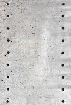 Gray metal structure, with holes. Scratched metal. Design background.