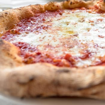 Pizza Margherita made with tasty pizza dough, mozzarella and tomatoes.