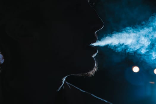 Close up portrait of young man smoking cigarette