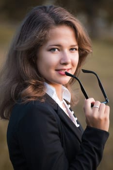 series. A portrait of the young business woman  in autumn park