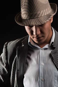 The man in style Chicago gangster on dark background