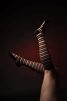 Pretty legs in a long multi-colored socks