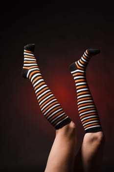Pretty legs in a long multi-colored socks