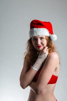 Pretty Santa girl closeup portrait, holding present gift box isolated on white background