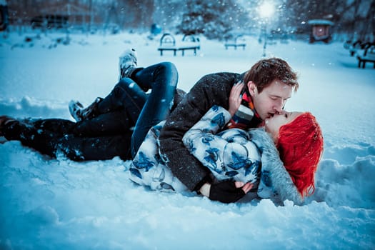Happy Young Couple in Winter Park having fun.Family Outdoors. love kiss