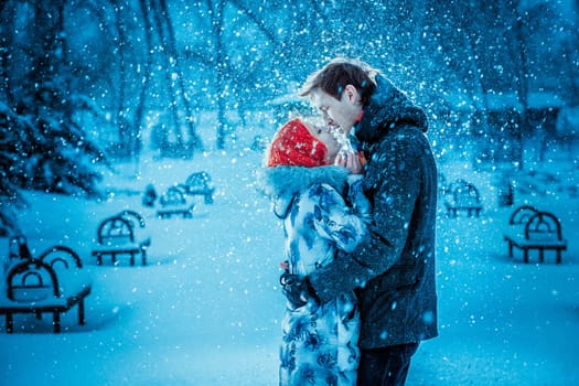 Happy Young Couple in Winter Park having fun.Family Outdoors. love kiss