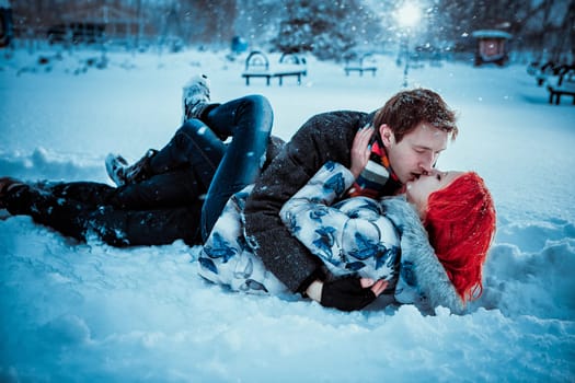 Happy Young Couple in Winter Park having fun.Family Outdoors. love kiss