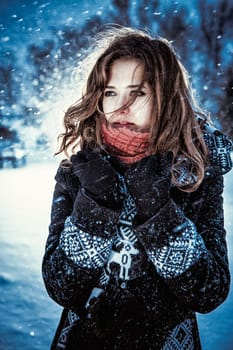 Beautiful brunette girl blowing star dust - winter portrait
