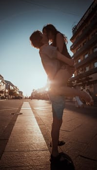 Young couple kissing over sunset