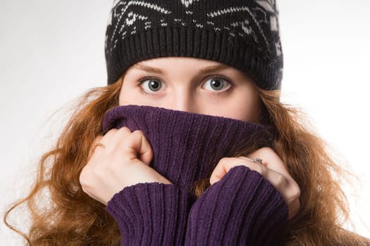 beautiful woman dressed in winter clothes smiling - studio shots