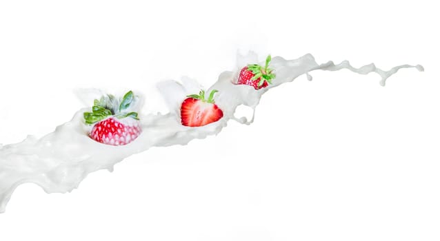 Strawberry falling into splashing milk. Isolated on white.