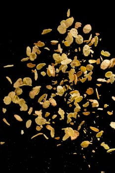 Flying corn flakes isolated on black background