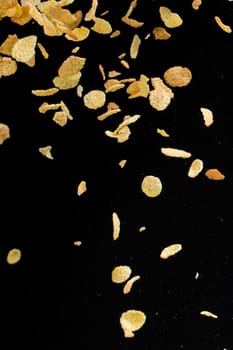 Flying corn flakes isolated on black background