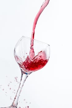 Red Wine Pouring into glass white isolated