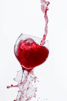 Red Wine Pouring into glass white isolated