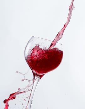 Red Wine Pouring into glass white isolated