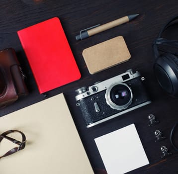 Personal traveler's items. Old photo camera and vintage stationery. Top view. Flat lay.