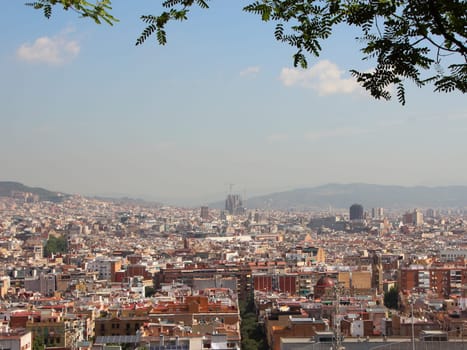 Barcelona Spain City Summer View with Sagrada Familia in Background. Smog is hiding the mountains.