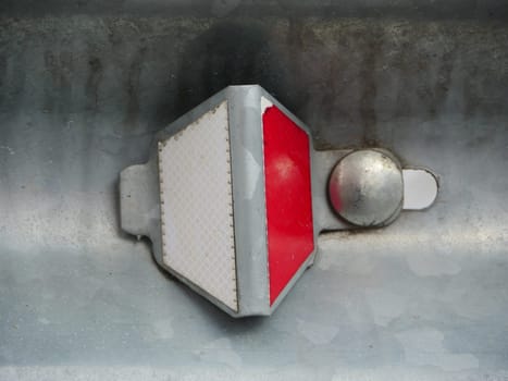 road reflector red and white retro-reflective optical unit close-up
