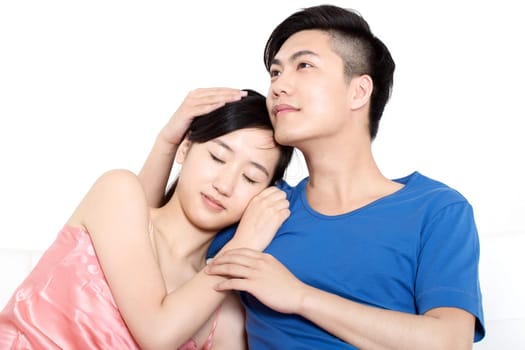 Young Chinese couple showing love in couch