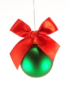 Green christmas ball with red bow isolated over white