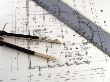 dividers and ruler laying on architectural plan