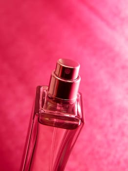 Bottle og parfume over pink background