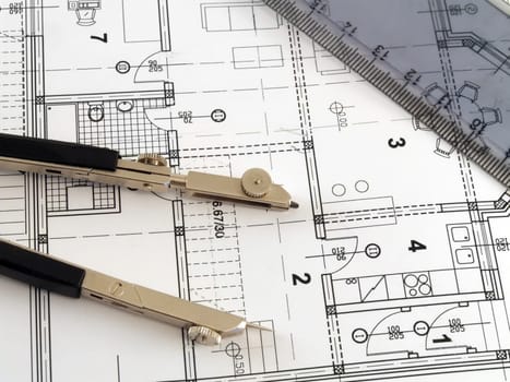 dividers and ruler laying on architectural plan