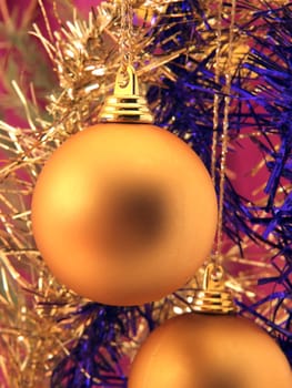 Golden christmas ornaments and shiny ribbons
