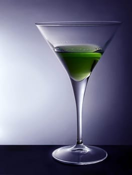 Cocktail glass with green beverage