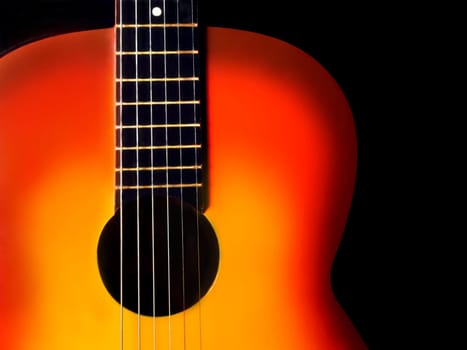 Red guitar isolated on the black background