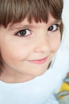 Closeup portrait of beautiful young girl in white