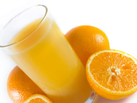 closeup orange juiceand few oranges on white
