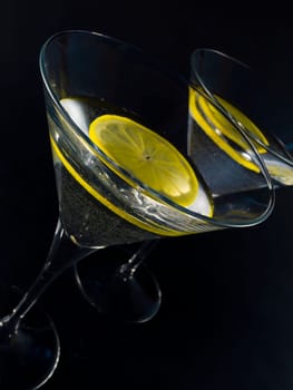 martini with lemon over black
