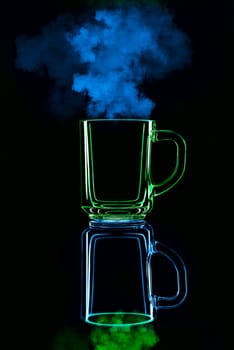 Just a glass on a black background with a reflection. Blue and green, with steam. Isolated.