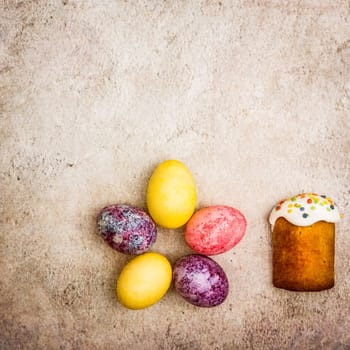 Easter cakes and Easter colored eggs on a beautiful textured background. Religious holiday of bright Easter.