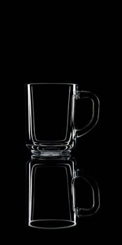 Just a glass on a black background with a reflection. Isolated.