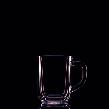 Just a glass on a black background with a reflection. Isolated.