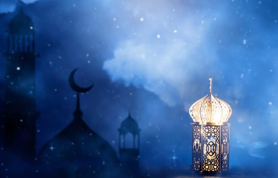 Ornamental Arabic lantern with crescent moon glowing at night. Festive greeting card for Muslim holy month Ramadan Kareem.