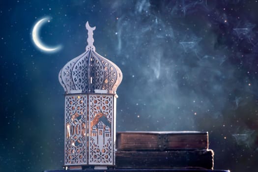 Ornamental Arabic lantern with crescent moon glowing at night. Festive greeting card for Muslim holy month Ramadan Kareem.