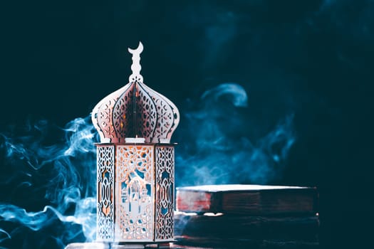 Ornamental Arabic lantern with with Holy Quran. Festive greeting card for Muslim holy month Ramadan Kareem.