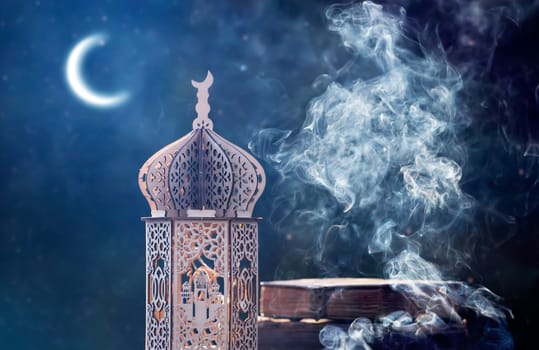 Ornamental Arabic lantern with crescent moon glowing at night. Festive greeting card for Muslim holy month Ramadan Kareem.