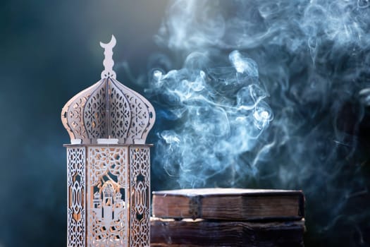 Ornamental Arabic lantern with with Holy Quran. Festive greeting card for Muslim holy month Ramadan Kareem.