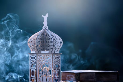 Ornamental Arabic lantern with with Holy Quran. Festive greeting card for Muslim holy month Ramadan Kareem.