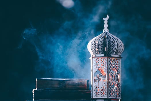 Ornamental Arabic lantern with with Holy Quran. Festive greeting card for Muslim holy month Ramadan Kareem.