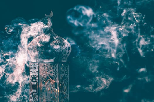 Ornamental Arabic lantern with smoke. Festive greeting card for Muslim holy month Ramadan Kareem.